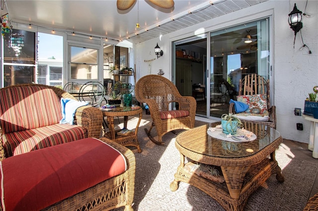 sunroom / solarium featuring ceiling fan