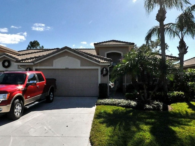 view of front of house featuring a garage and a front lawn