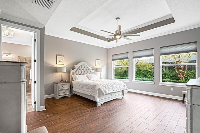 bedroom with ceiling fan, dark hardwood / wood-style flooring, a textured ceiling, and crown molding