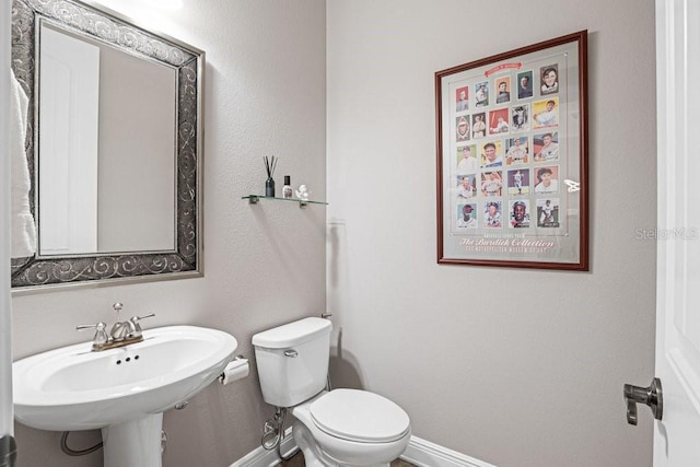 bathroom featuring sink and toilet