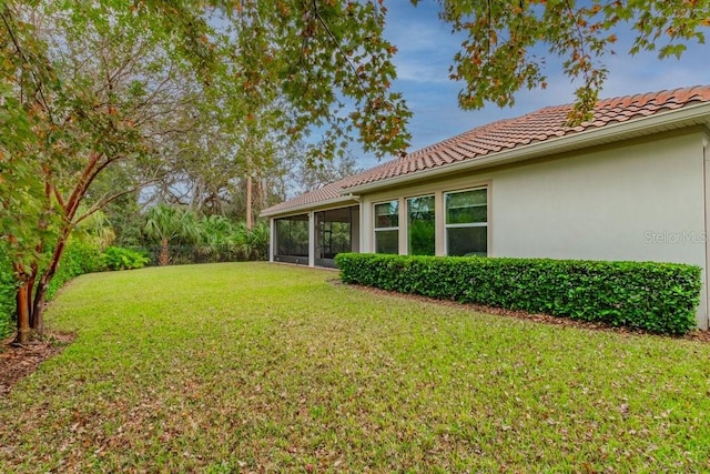 view of yard with a sunroom