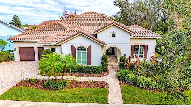 mediterranean / spanish-style house featuring a garage