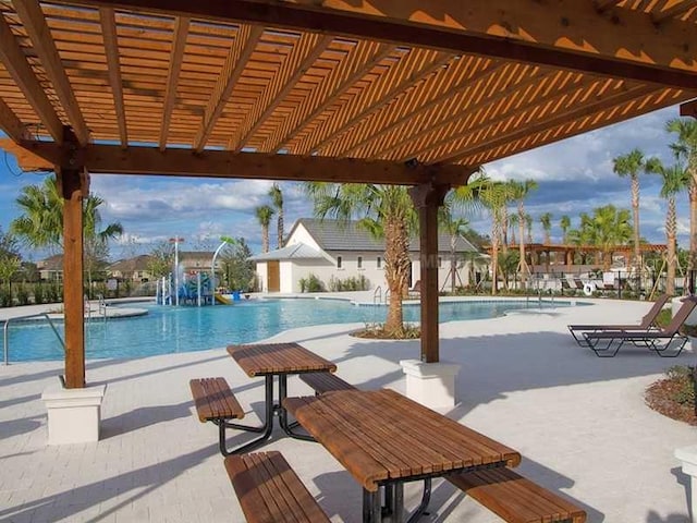 view of swimming pool with a patio area and a pergola