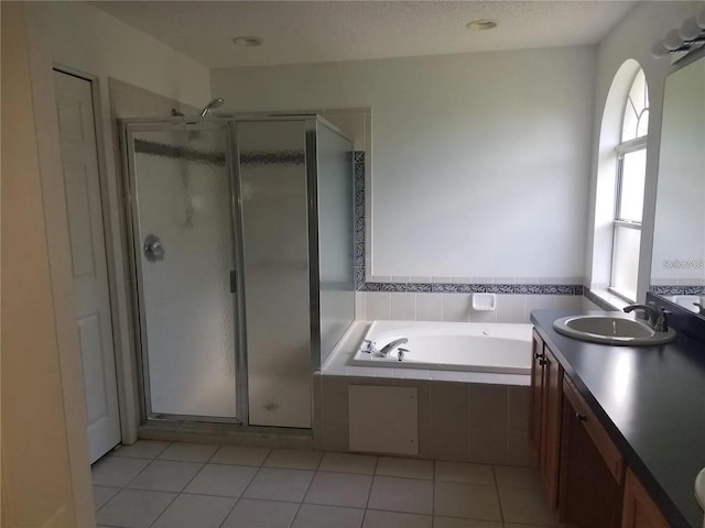 bathroom featuring vanity, a healthy amount of sunlight, and independent shower and bath