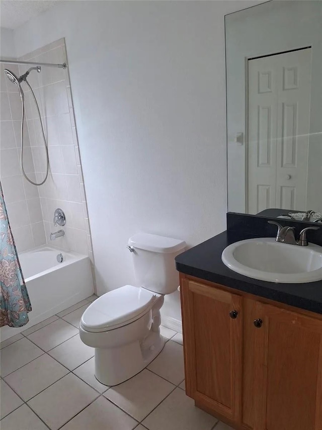 full bathroom with tile patterned floors, vanity, toilet, and shower / bath combo