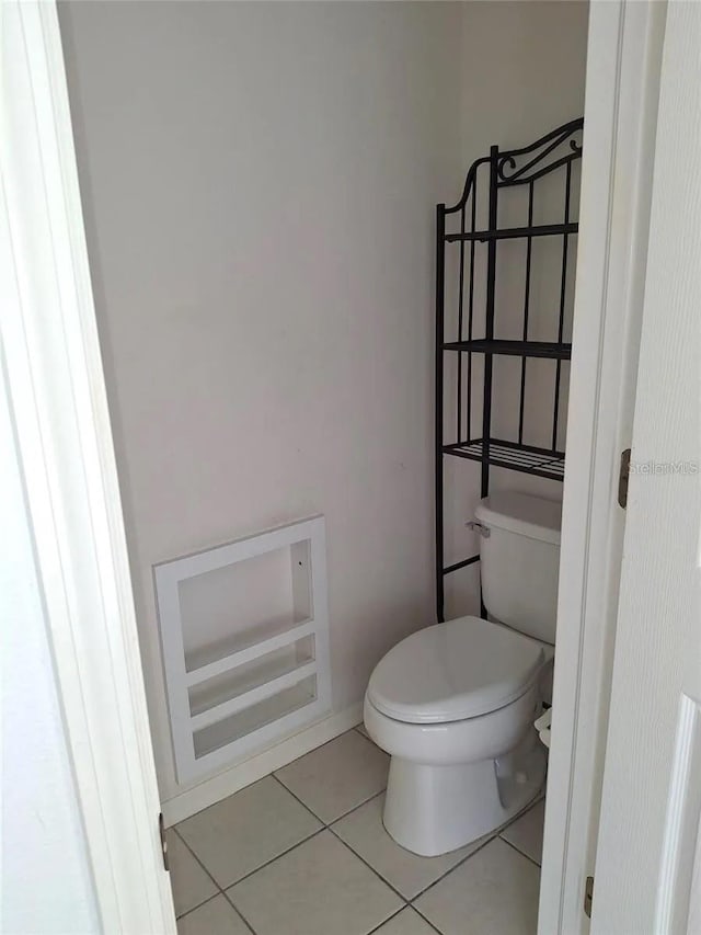 bathroom featuring tile patterned floors and toilet