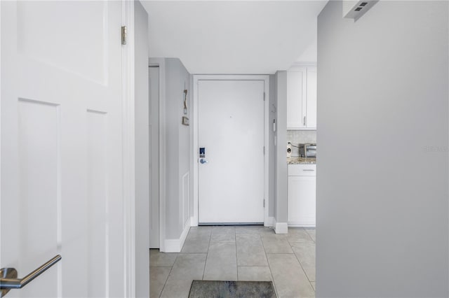 corridor featuring light tile patterned floors