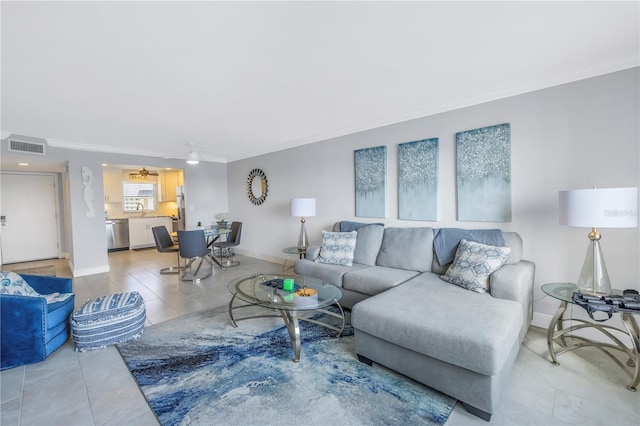 living room featuring crown molding, sink, and ceiling fan