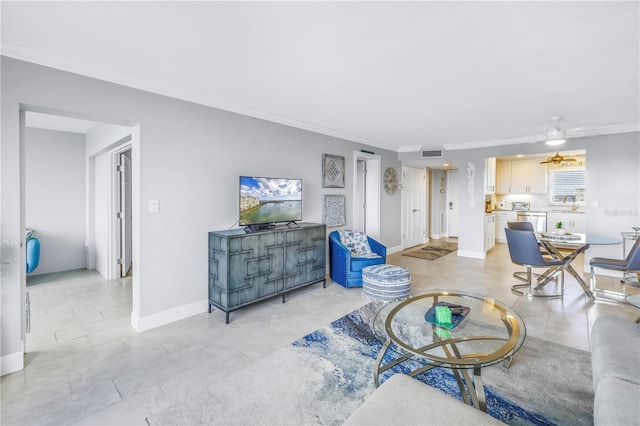 living room featuring ceiling fan, ornamental molding, and sink