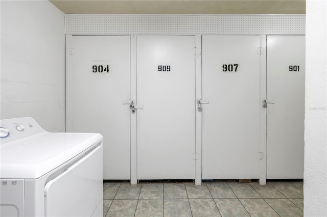 laundry room featuring light tile patterned floors and washer / dryer