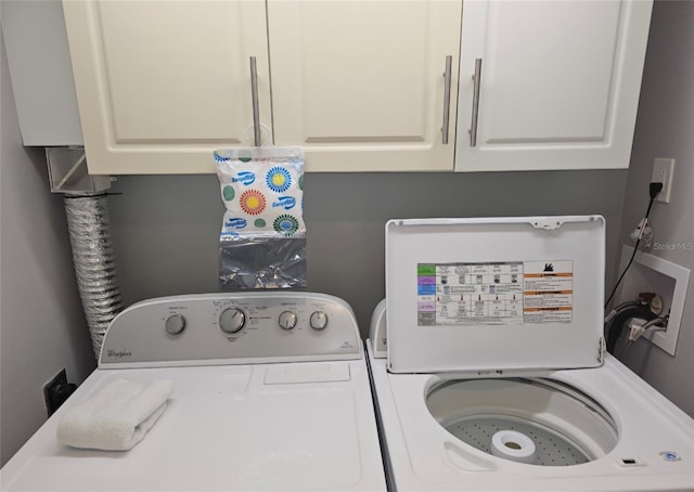 laundry room featuring cabinets and washing machine and clothes dryer