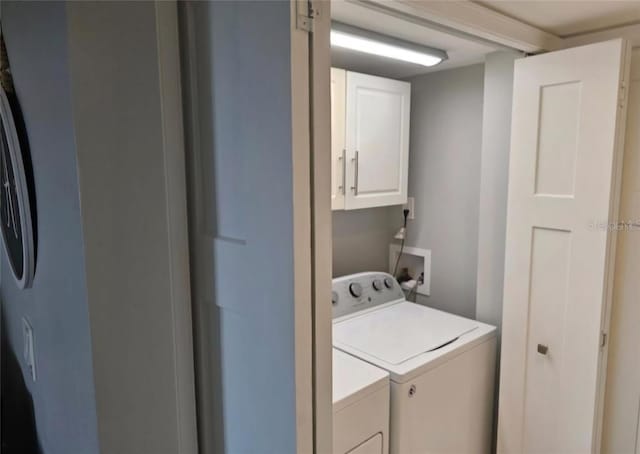 laundry area featuring cabinets and separate washer and dryer