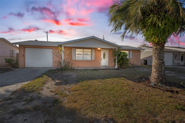 single story home featuring a yard and a garage