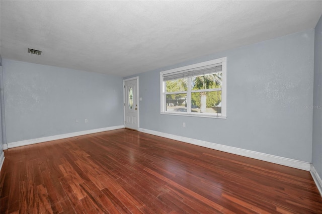 empty room featuring hardwood / wood-style floors and a textured ceiling