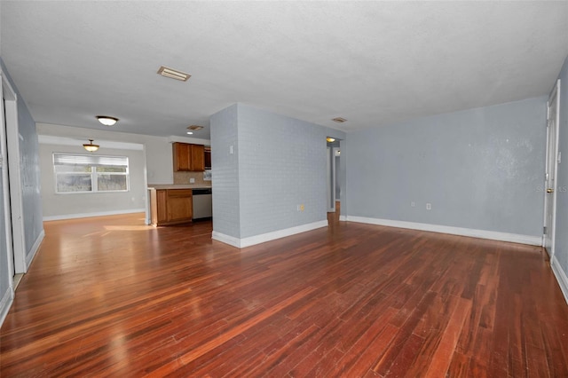 unfurnished living room with dark wood-type flooring