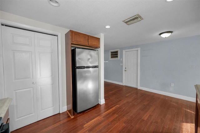 kitchen featuring dark hardwood / wood-style floors and stainless steel refrigerator