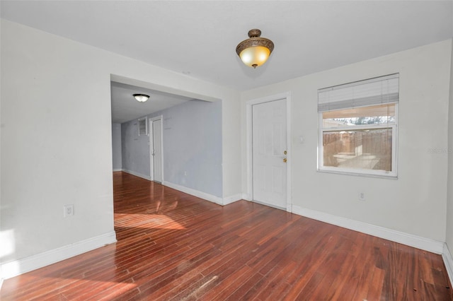 spare room featuring dark wood-type flooring