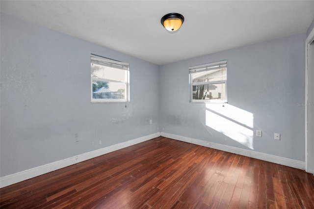 spare room featuring dark hardwood / wood-style floors