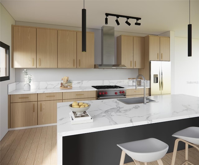 kitchen with white refrigerator with ice dispenser, stainless steel stove, hanging light fixtures, and wall chimney exhaust hood