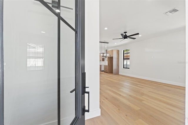 interior space featuring visible vents, baseboards, ceiling fan, light wood-type flooring, and recessed lighting