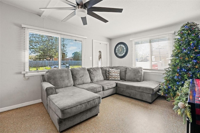 living room with plenty of natural light and ceiling fan