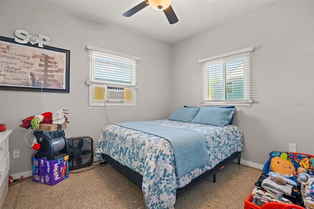 bedroom with ceiling fan, cooling unit, and multiple windows