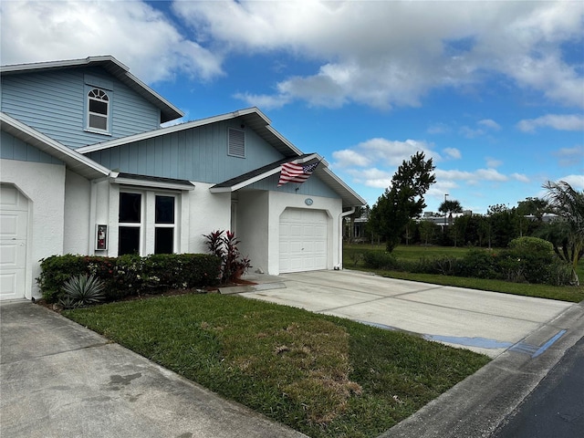 view of side of home with a yard and a garage