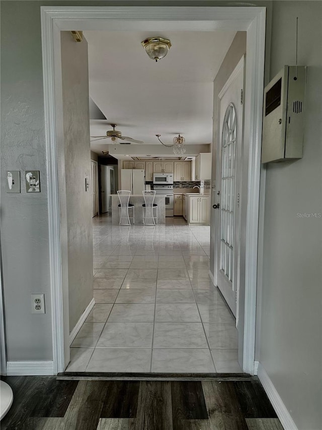 corridor with light hardwood / wood-style floors