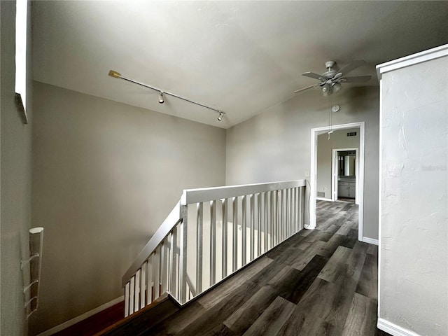 corridor with dark hardwood / wood-style flooring and lofted ceiling