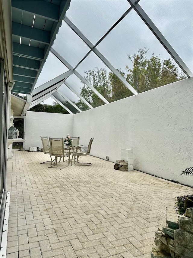 view of patio / terrace featuring a lanai