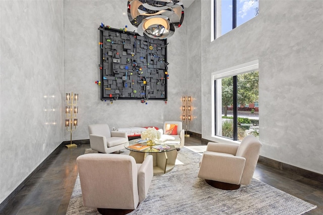 living room featuring a towering ceiling and an inviting chandelier