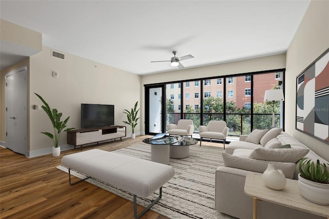 living room with wood-type flooring and ceiling fan