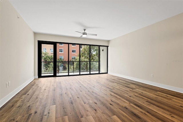 spare room with hardwood / wood-style floors and ceiling fan