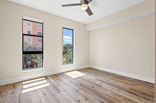 spare room with light hardwood / wood-style floors and ceiling fan