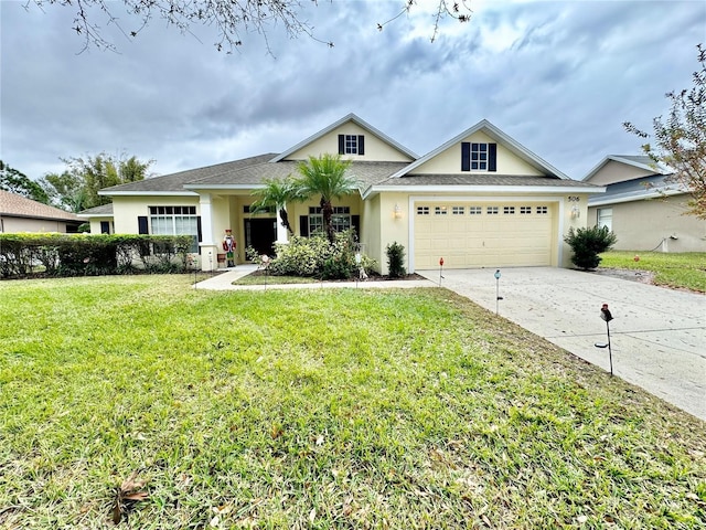 view of front of property featuring a garage and a front lawn