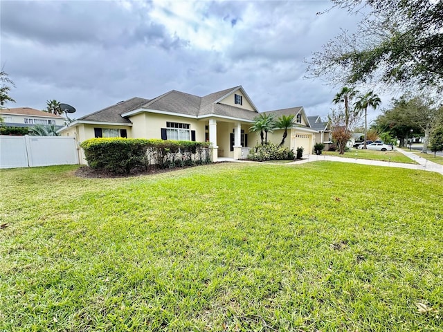 view of front of house featuring a garage and a front lawn