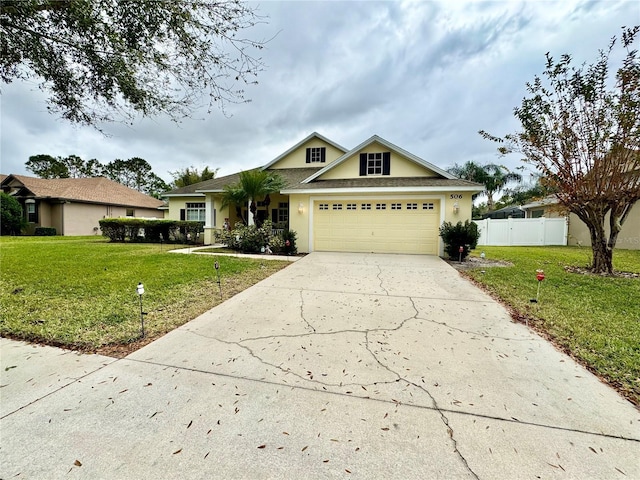 view of front of home with a front yard and a garage