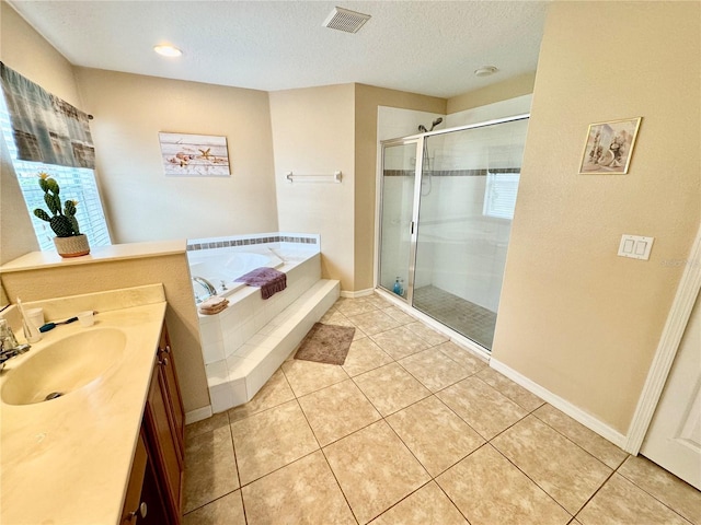 bathroom featuring tile patterned floors, separate shower and tub, vanity, and a textured ceiling