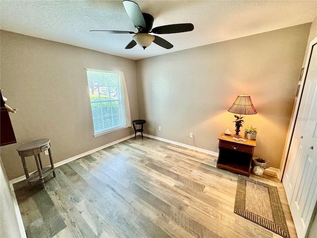 interior space with ceiling fan and hardwood / wood-style floors