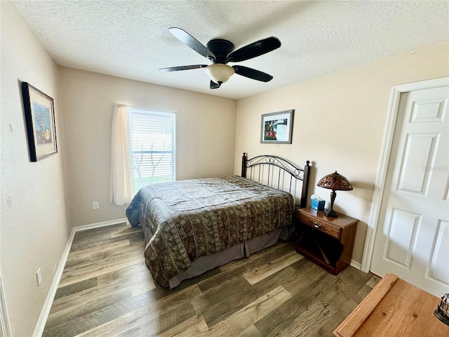 bedroom featuring a textured ceiling, hardwood / wood-style flooring, and ceiling fan