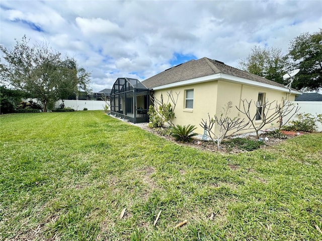 exterior space featuring a yard and a lanai