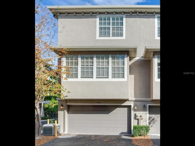 multi unit property featuring cooling unit and a garage