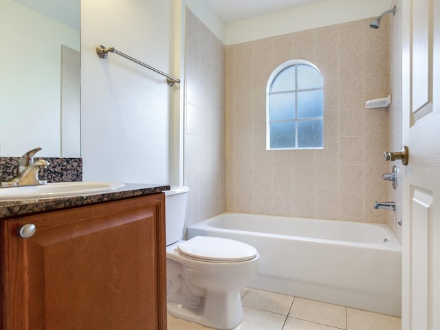 full bathroom with tile patterned flooring, vanity, toilet, and tiled shower / bath