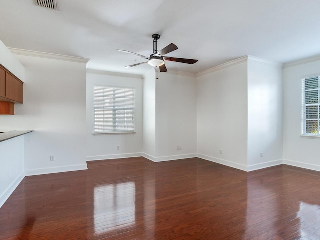 unfurnished living room with ornamental molding, ceiling fan, and dark wood-type flooring