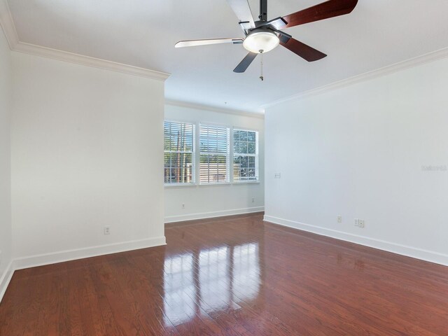 unfurnished room with ornamental molding, ceiling fan, and dark wood-type flooring