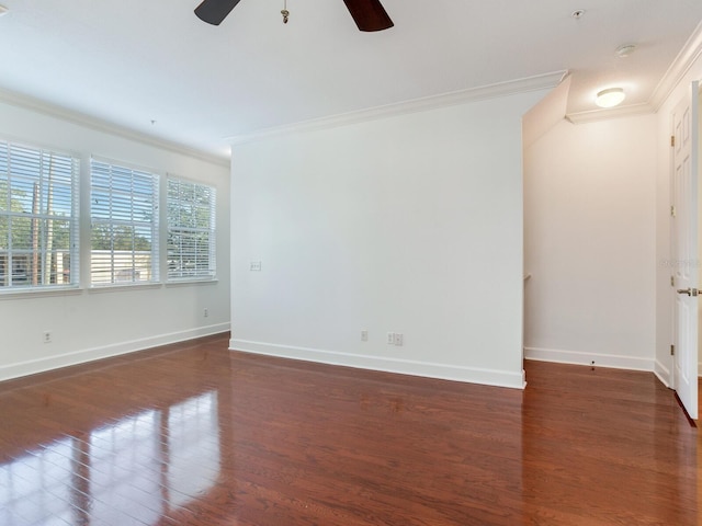 empty room with dark hardwood / wood-style flooring, ceiling fan, and ornamental molding