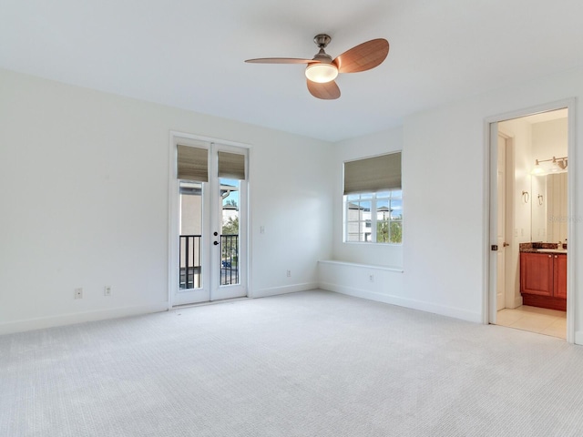 carpeted empty room featuring a wealth of natural light and ceiling fan