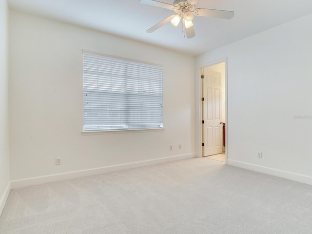 carpeted empty room featuring ceiling fan