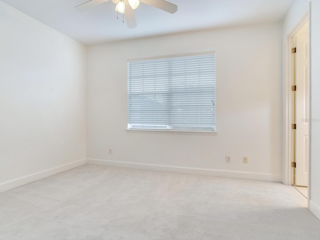 unfurnished room with light carpet and ceiling fan