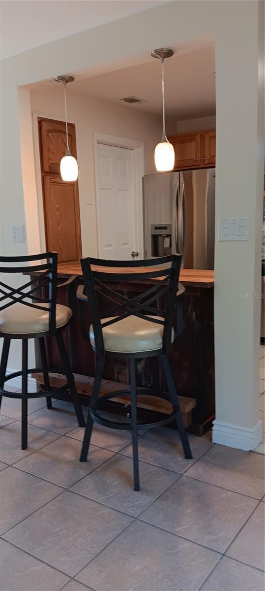 dining area with light tile patterned floors